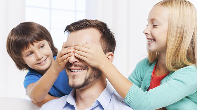 Kids blindfolding dad